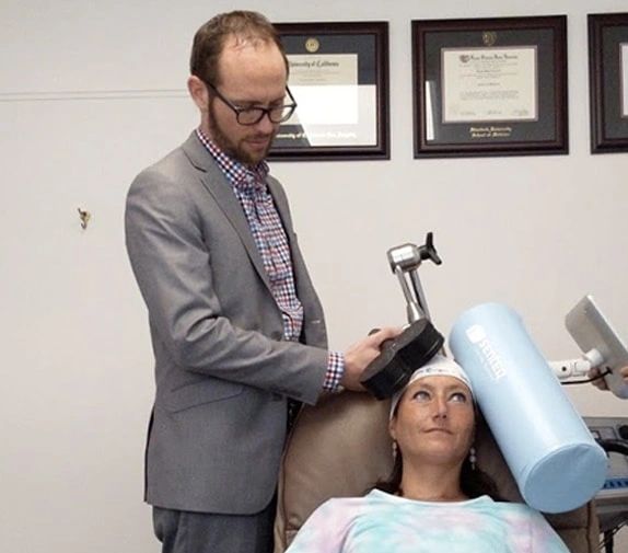 Dr. Carreon treating a patient with TMS.